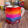 Handmade resin decorative mug sculpture with painted book and coffee cup design.