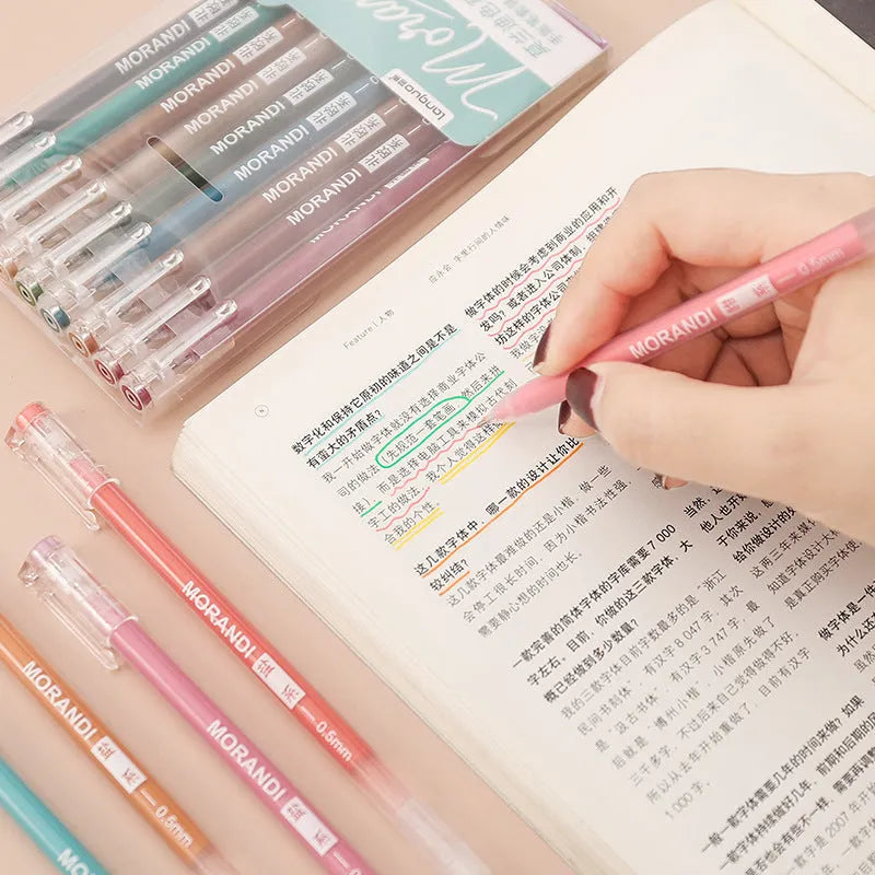 Set of nine gel pens with 0.5mm needle tips in a white plastic storage case.