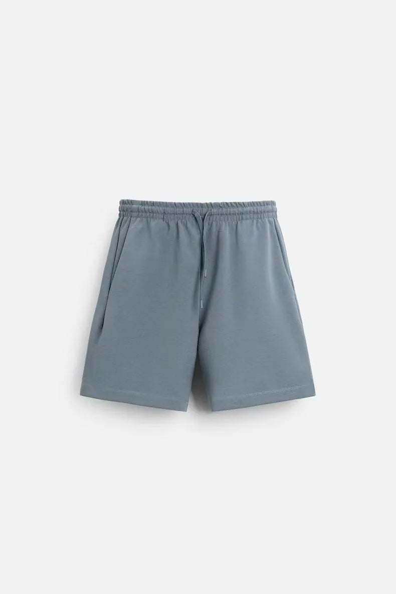 Loose double-sided cloth texture short sleeve top and matching shorts set in blue on a model.