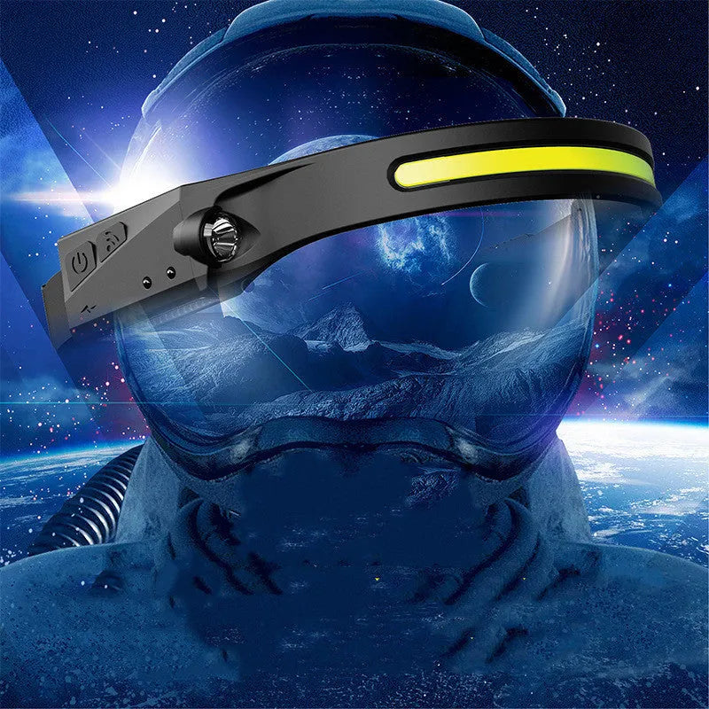 Black USB rechargeable headlamp with a wide COB LED lens and a side wave sensor on the headband.