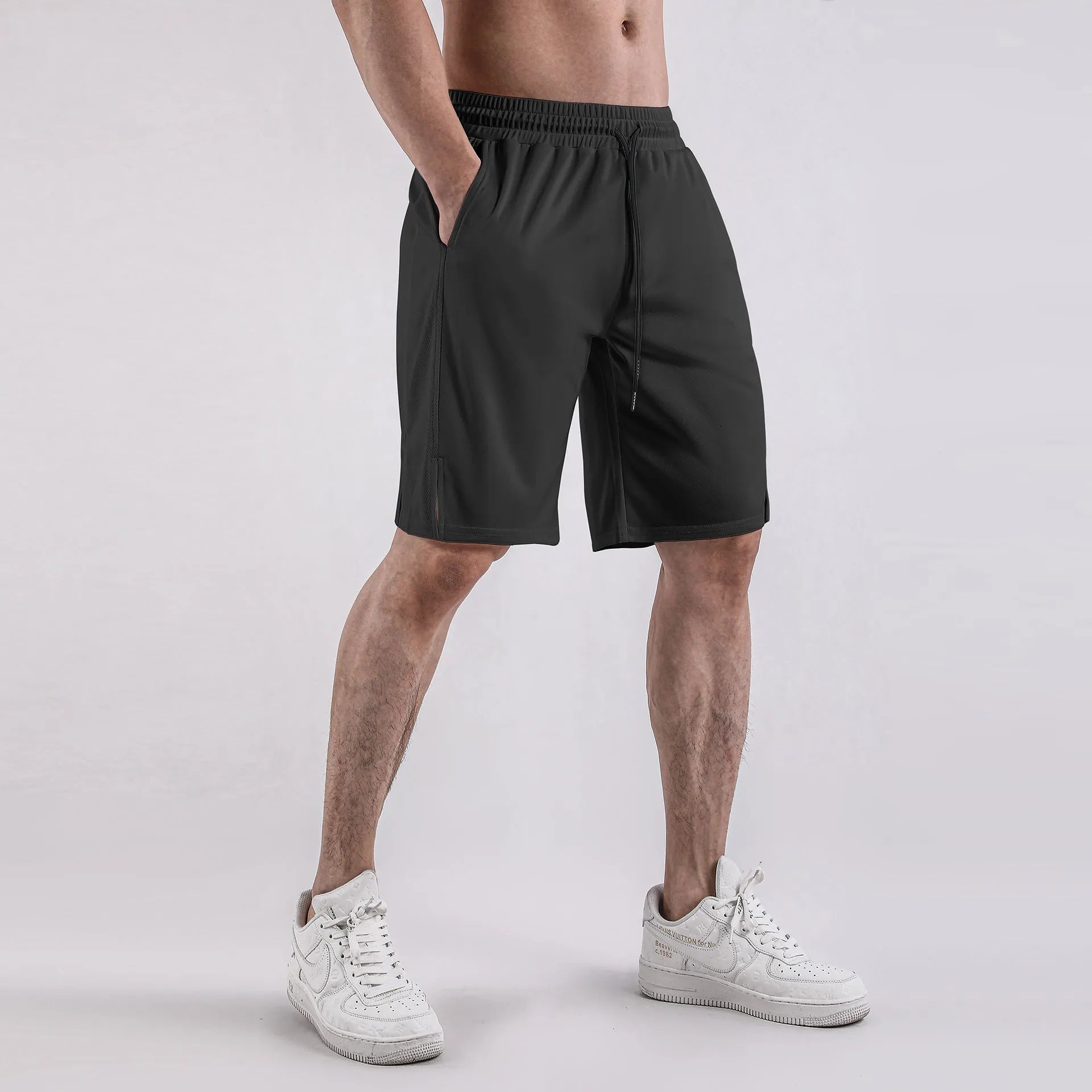 Men's black quick-drying mesh shorts with elastic waistband and loose fit.