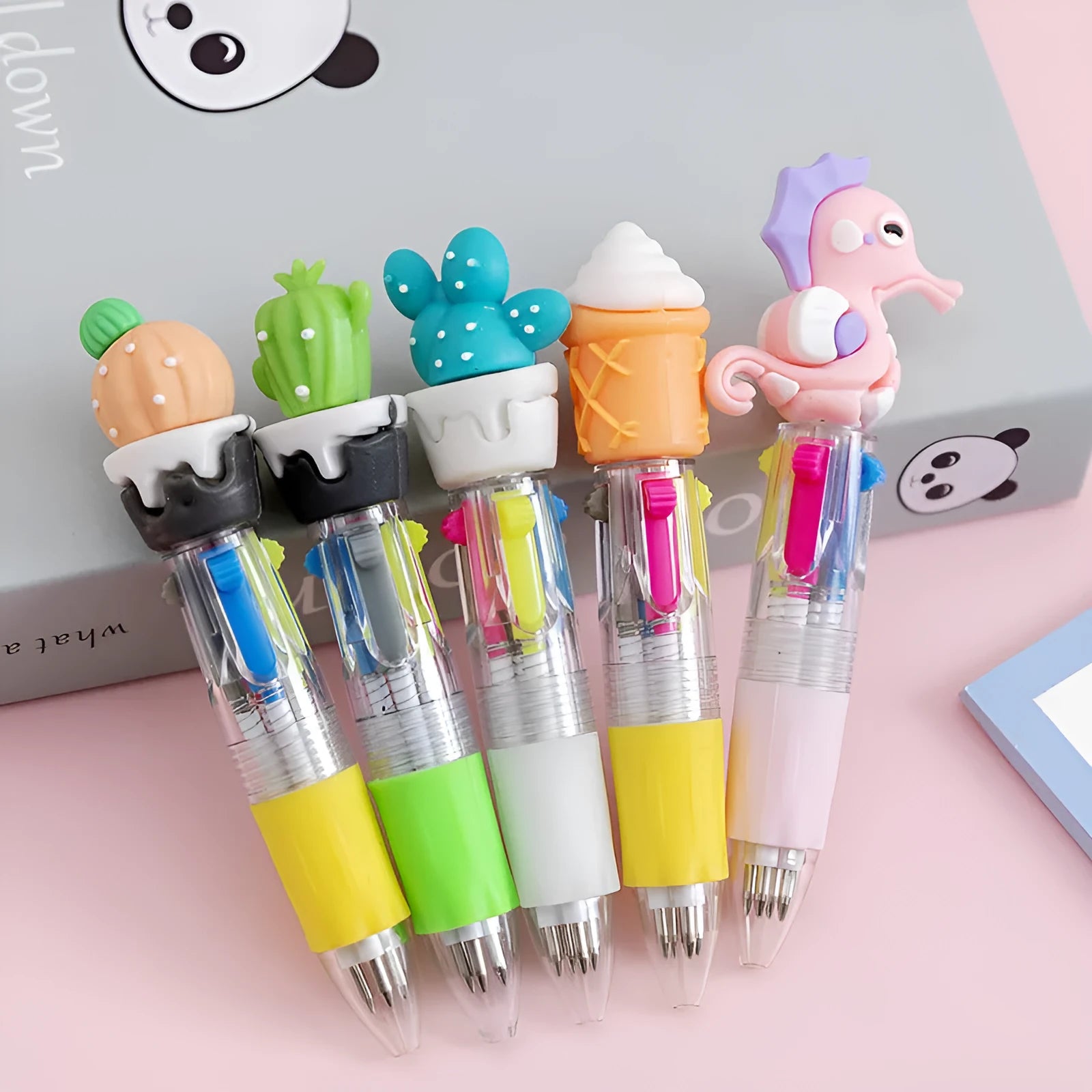 A four-colour ballpoint pen with a press top and a cute cartoon design on a silicone grip section.