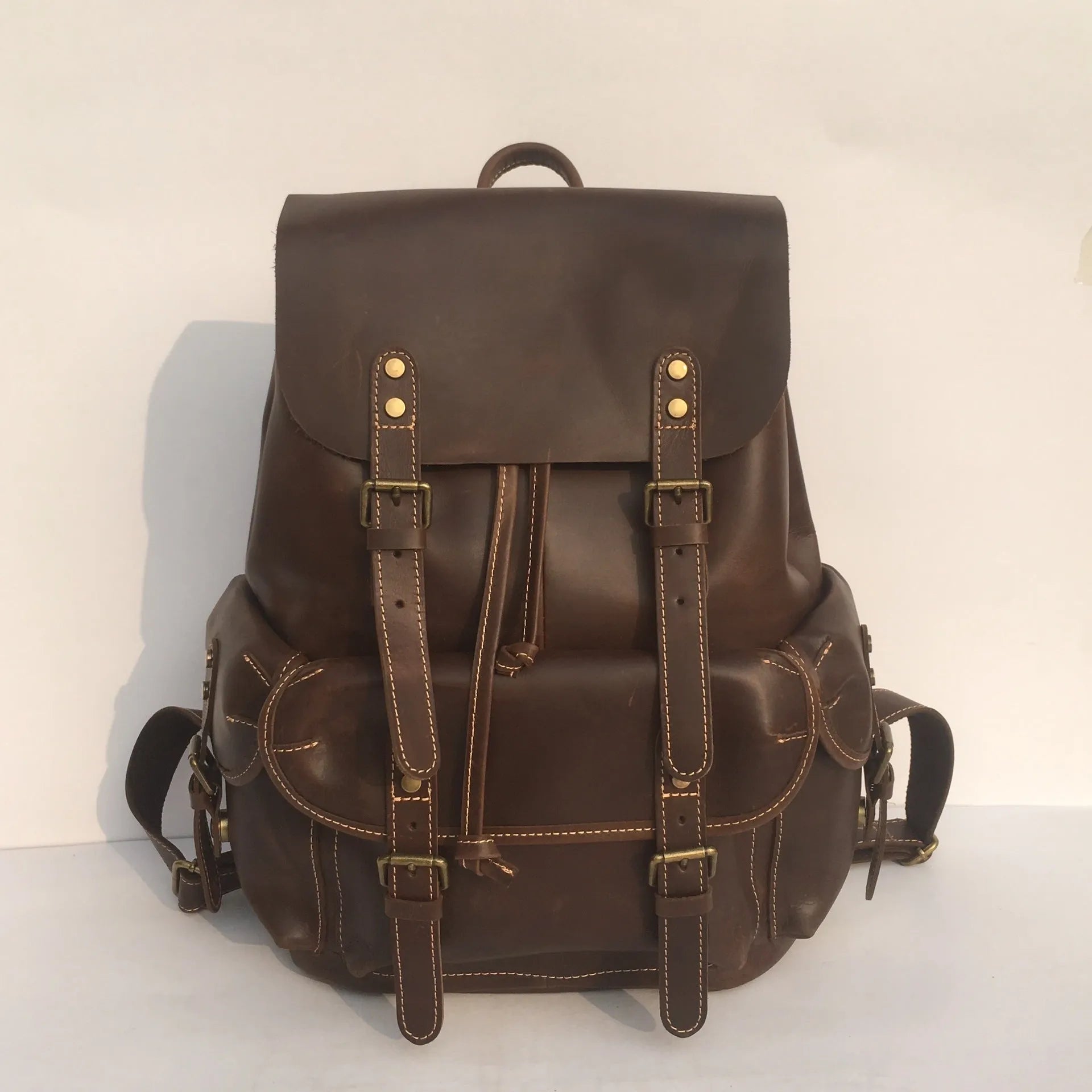 Brown men's cowhide leather backpack with air pillow shoulder straps and a single main compartment.