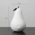 Handmade resin apple and pear decorative sculptures in various colours on a shelf