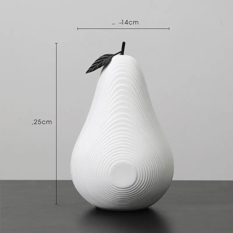 Handmade resin apple and pear decorative sculptures in various colours on a shelf