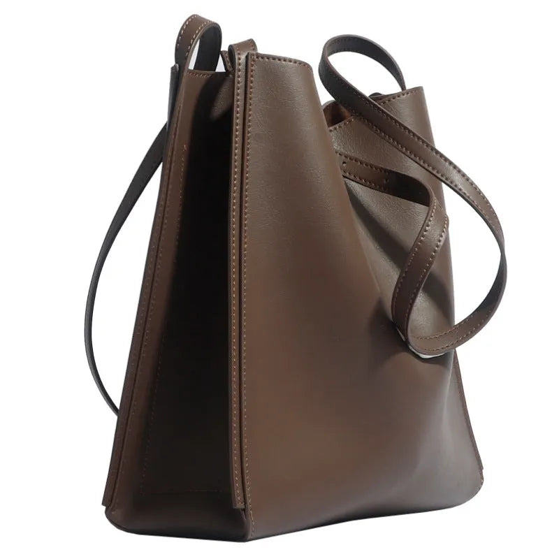 Brown genuine leather women's commuter bag with shoulder straps showing interior organisation compartments