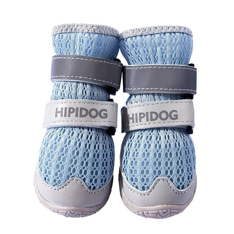 Pair of light blue breathable dog shoes with mesh upper and PU sole on a wooden surface.
