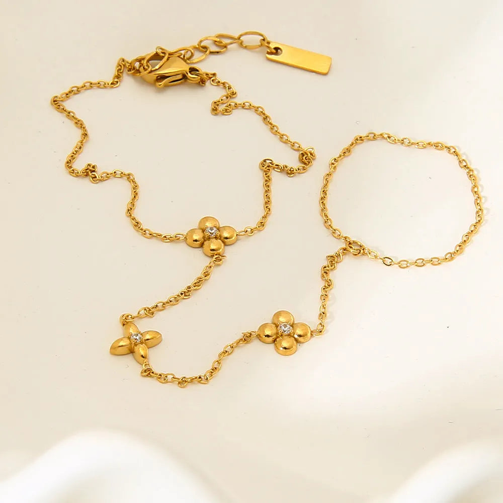 Gold geometric women's bracelet with floral and eight-pointed star design on stainless steel