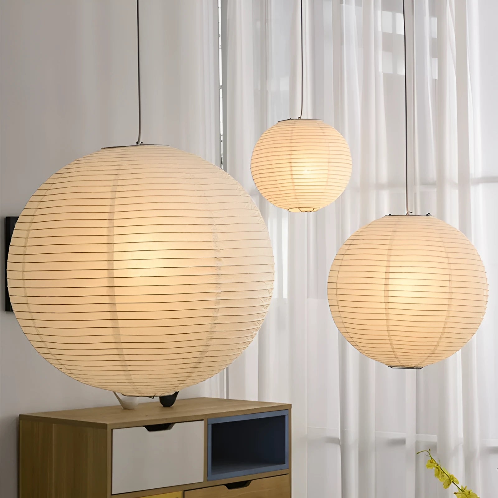 Modern simplicity paper pendant lamp with a round paper shade, shown in a dining room setting.