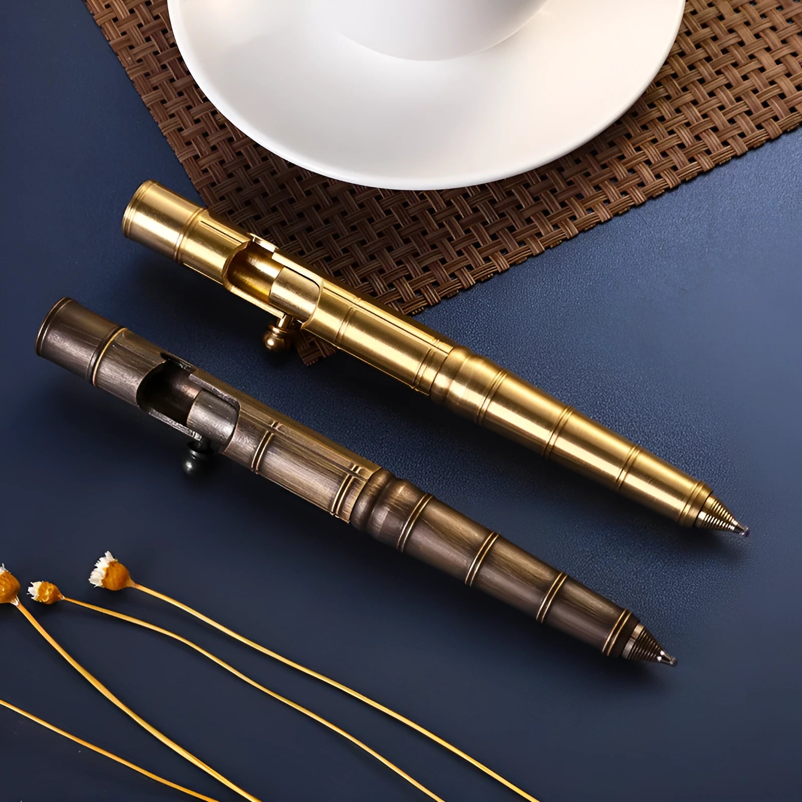 Brass tactical pen with six-ring press mechanism and cylindrical design in metallic finish