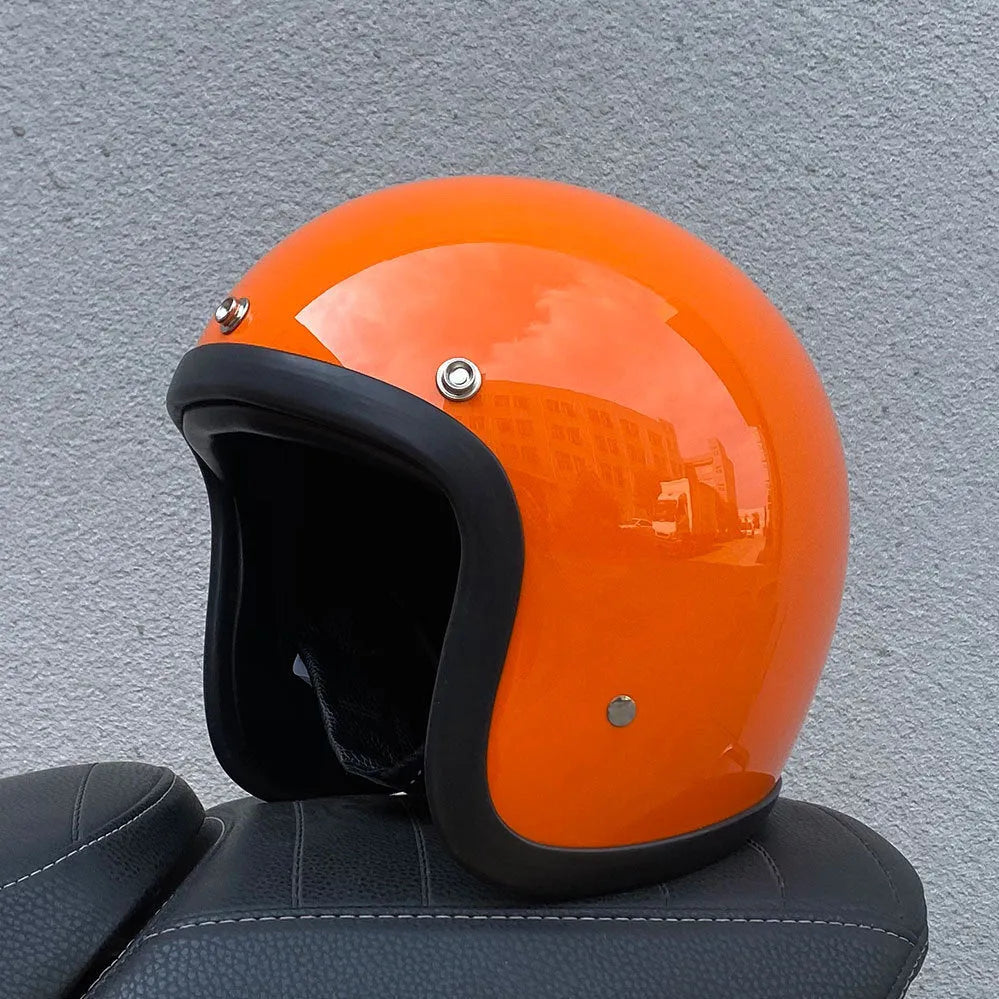 Retro-style half motorcycle helmet in fibreglass, shown in Cement Grey colour on a stand.