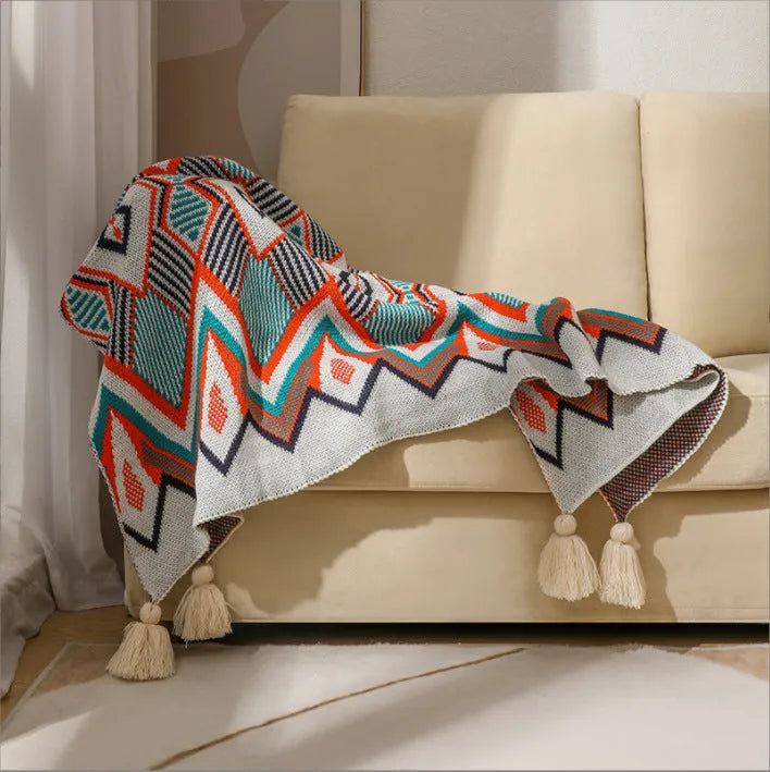 Bohemian-style acrylic knit sofa blanket with tassels in a geometric pattern
