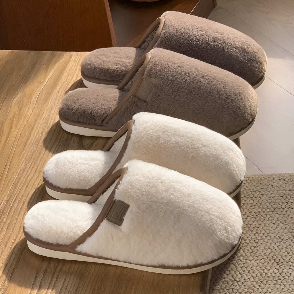 Pair of solid colour plush house slippers with a non-slip PVC sole, shown in coffee brown.