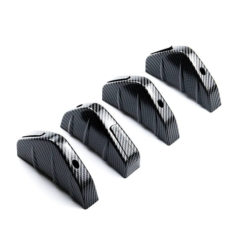 Black triangular car rear spoiler on a white background, shown with screws and adhesive tape.