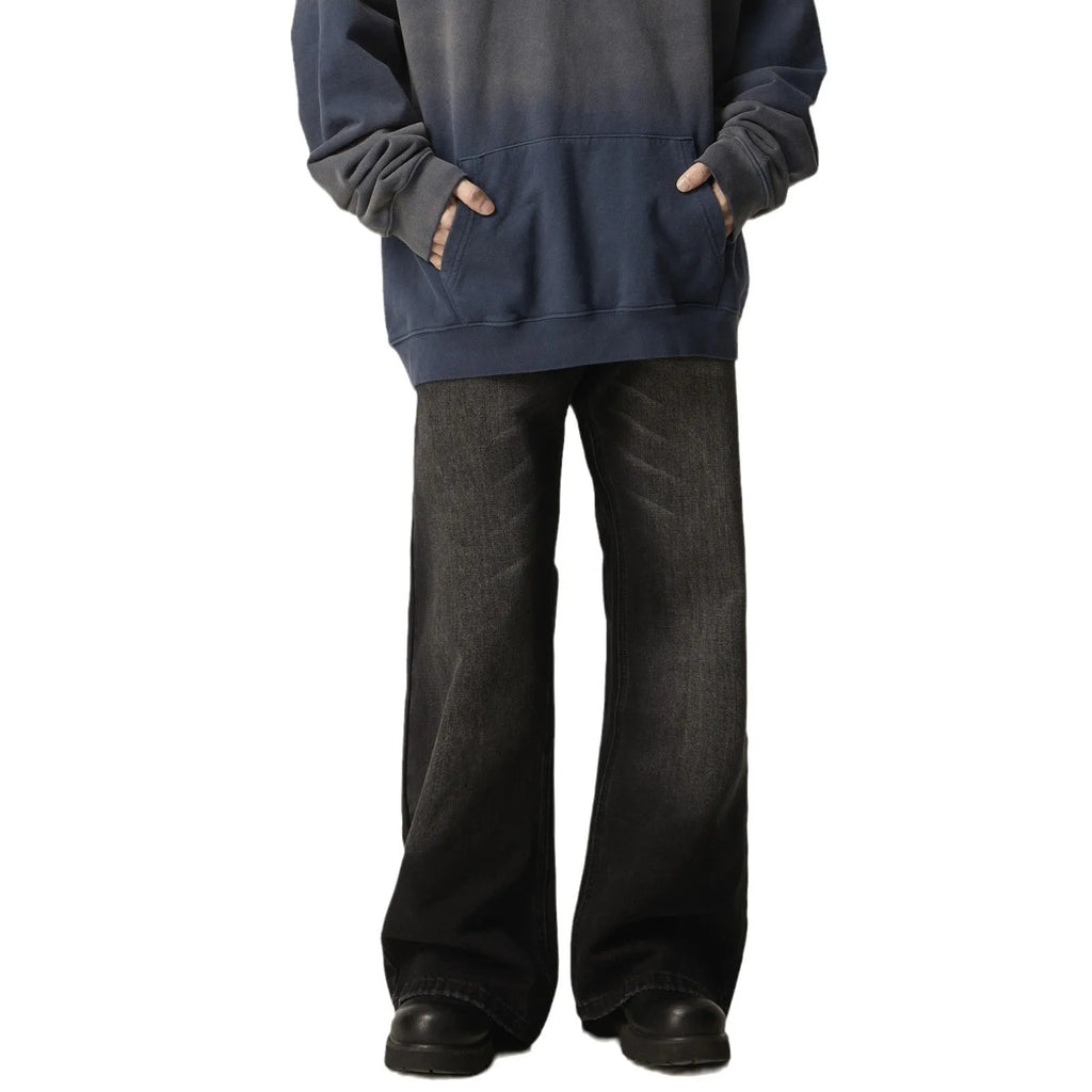 A pair of black loose-fit straight-leg jeans with a retro style on a white background.
