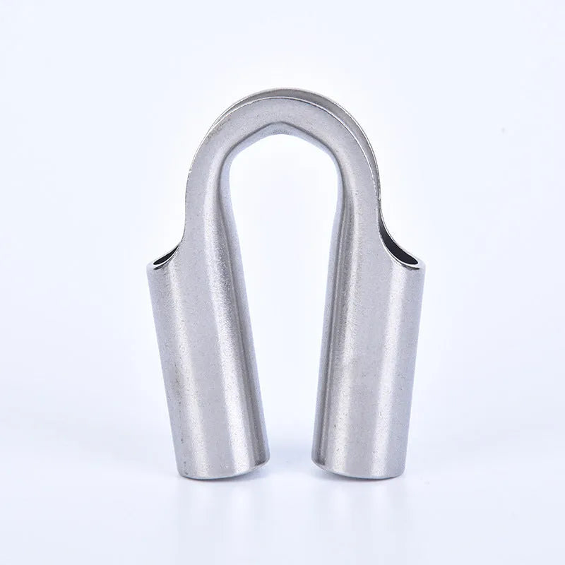 Set of stainless steel tubular chicken heart sleeve rings in various sizes on a workbench.