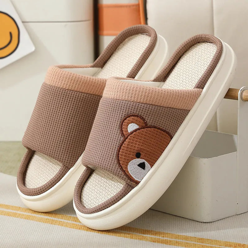 Pair of women's cartoon bear slippers with cotton linen upper and non-slip PVC sole, in light brown colour