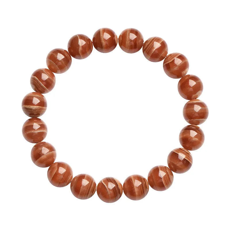 Natural Old Mine Rhodochrosite mineral bracelet with round beads in 6mm or 8mm size on a wrist.