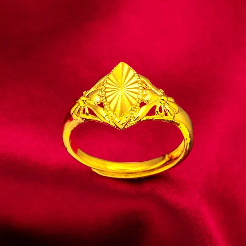 Adjustable gold-coloured brass floral ring with openwork design and textured diamond details.