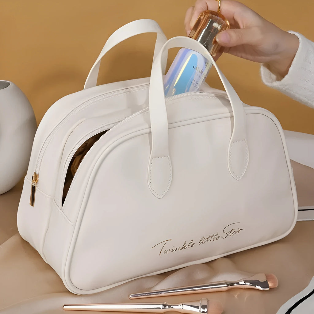 Large leather-look travel toiletry bag in caramel mocha colour with letter detailing, shown open.