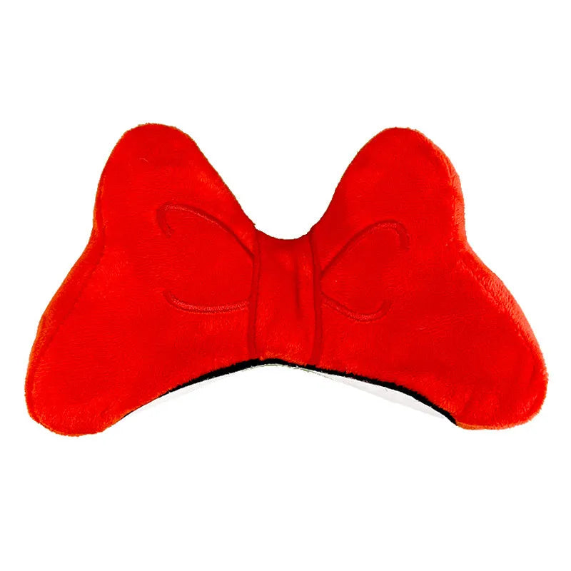 Soft plush bow tie decoration for helmets in red, peach pink, and rose pink on a motorcycle helmet.