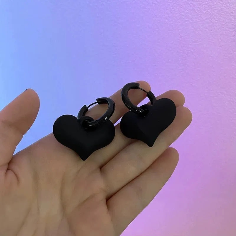 Black heart-shaped earrings with glass inlay in Korean style, shown as one pair