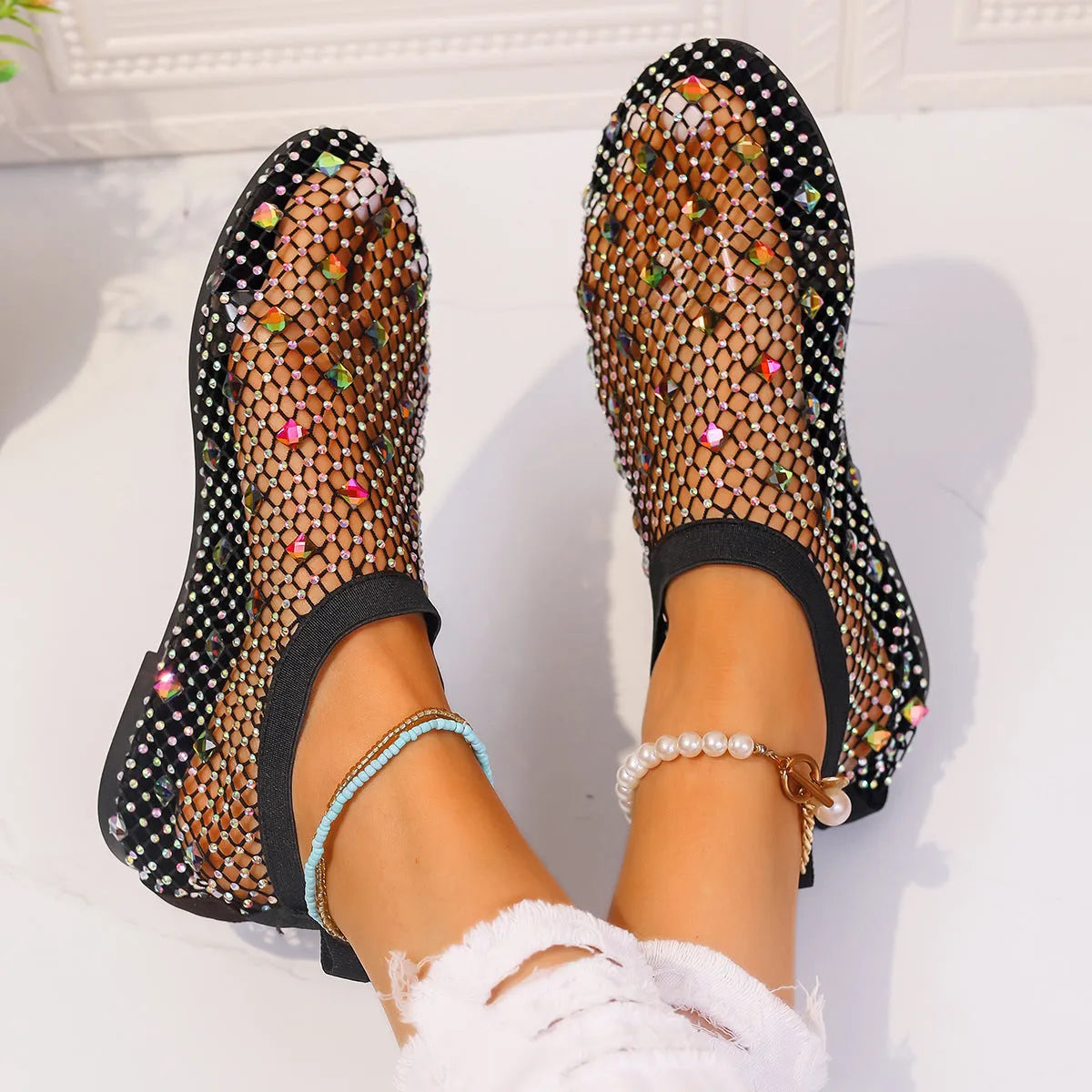 Women's colourful rhinestone flat sandals with mesh upper and rubber sole.