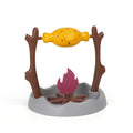 Barbecue-themed plastic tumbling cat treat feeder toy on a floor.