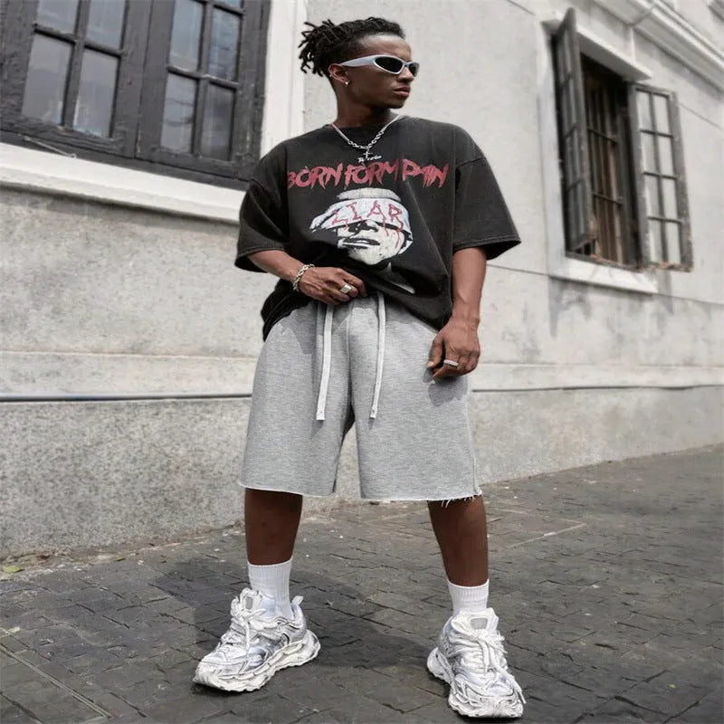 Men's straight-leg track trousers in black, shown in a casual streetwear style.