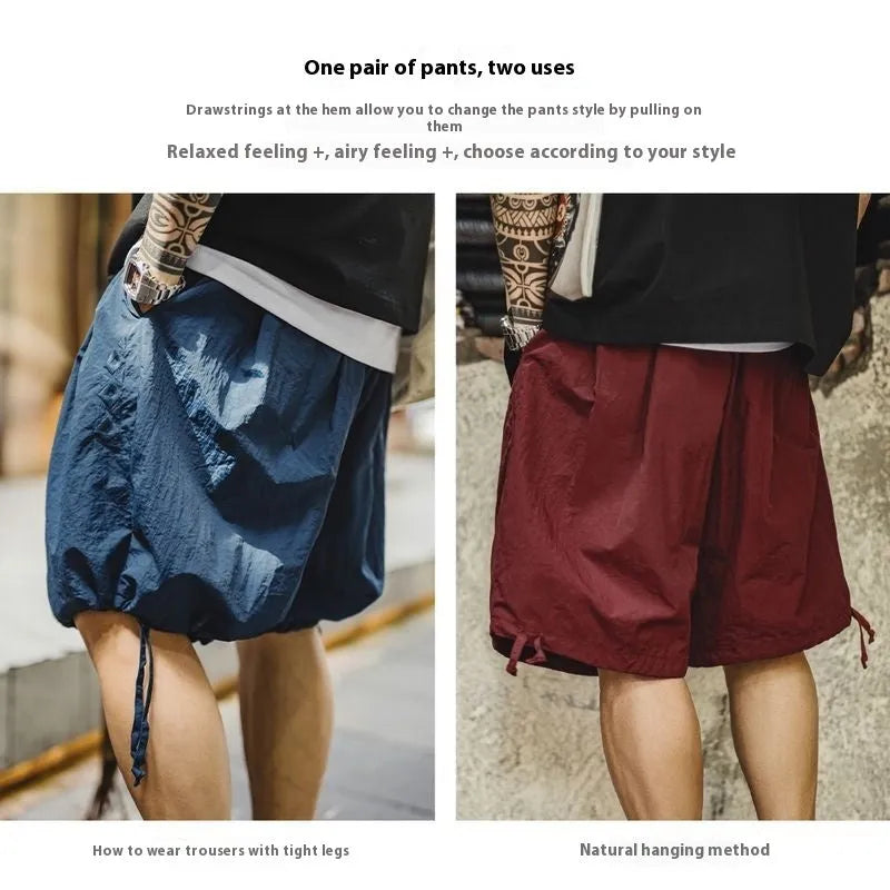 Men's loose-fit nylon beach shorts in Prussian blue colour with embroidered design details