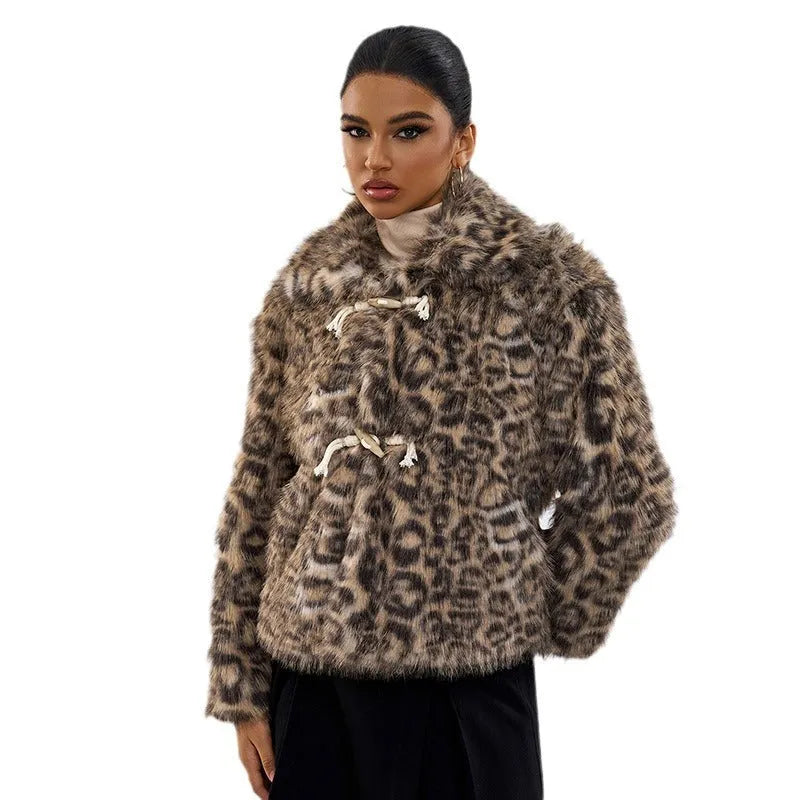 Women's leopard print coat with a buckle lapel closure on a hanger.