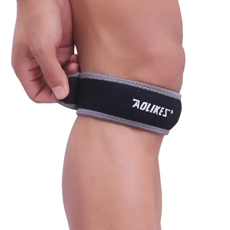 Black and grey patella retinaculum knee pad for sports protection.