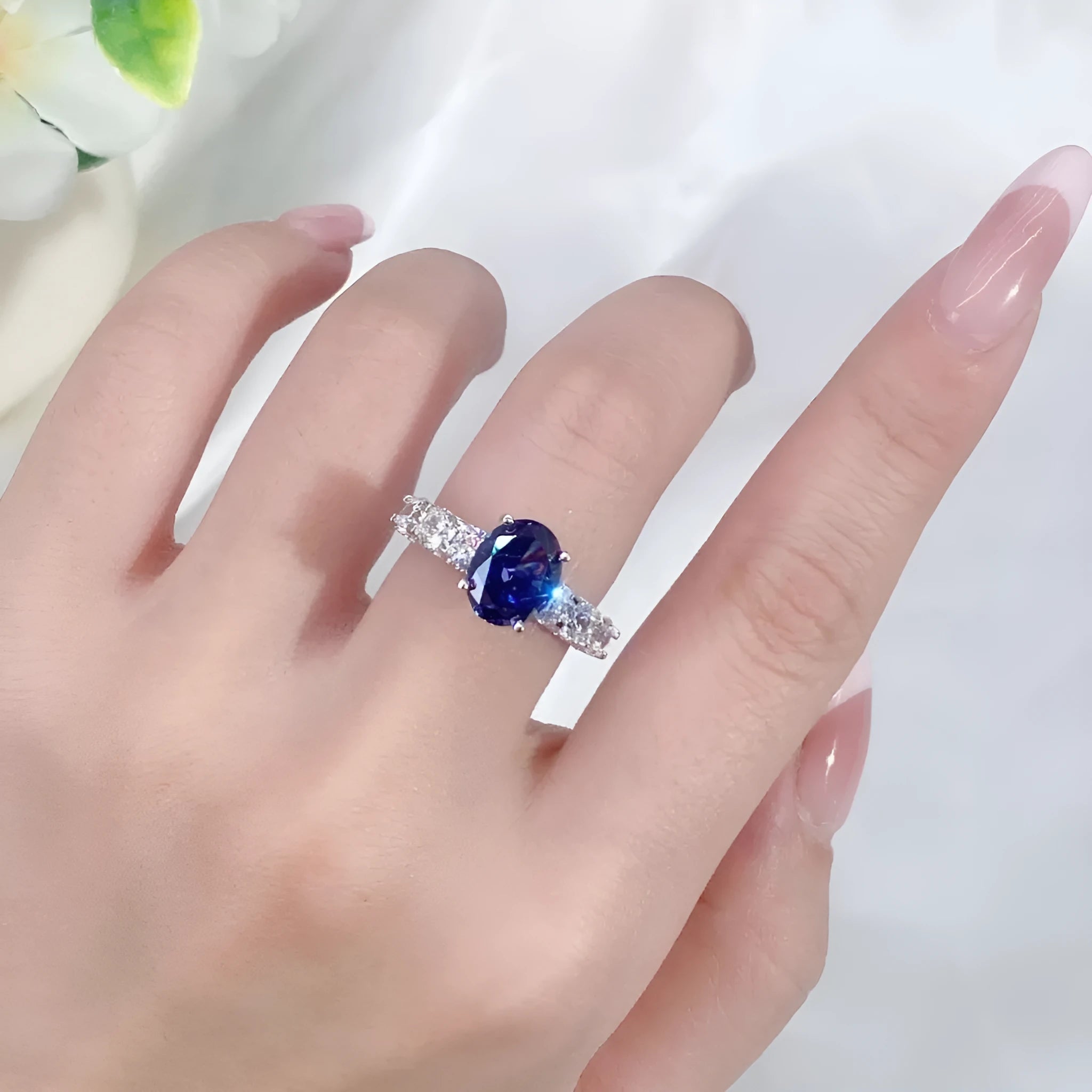 Heart-shaped sterling silver ring with ice flower cut zircon stone in a Tan Sang colour on a finger.