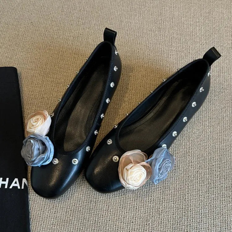 Women's silver Mary Jane loafers with flower rivets, buckle strap, round toe, and flat rubber sole.