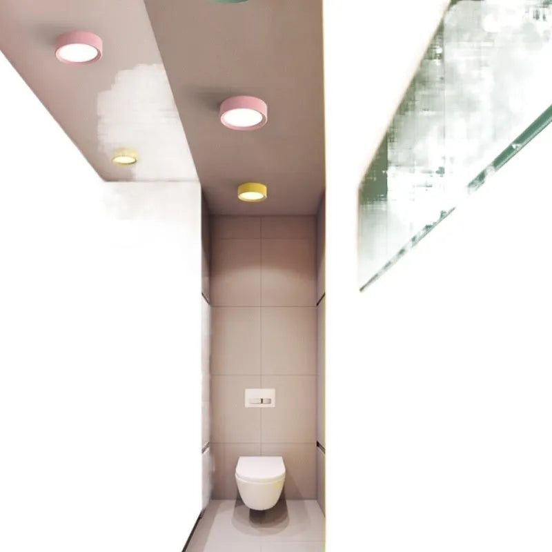 Ultra-thin surface mounted LED downlight in a choice of seven shell colours including black, white, gold, and pink.