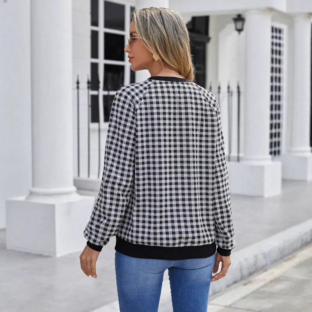 Black plaid stripe long sleeve pullover sweater laid flat, showing Japanese style pattern.