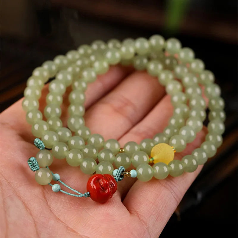 Pale blue Hetian jade bracelet with 6mm beads in three-circle design on wrist