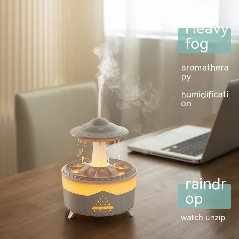 White UFO-shaped cloud humidifier with mist and soft blue night light on a wooden table