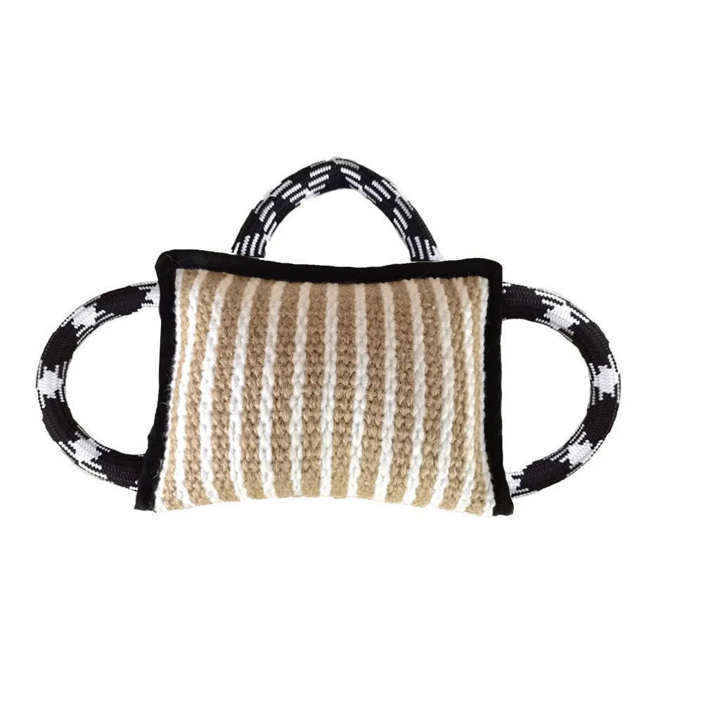 Dog tug of war toy with blue jute bite pillow and three rope handles on a wooden floor.