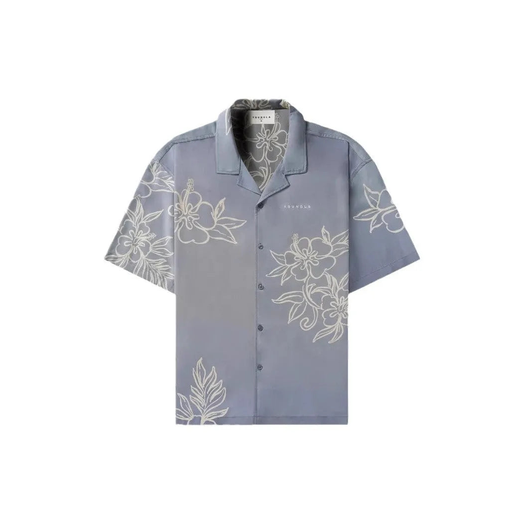 Man's loose-fitting printed short sleeve top in a light colour, showing cardigan style and floral pattern detail.