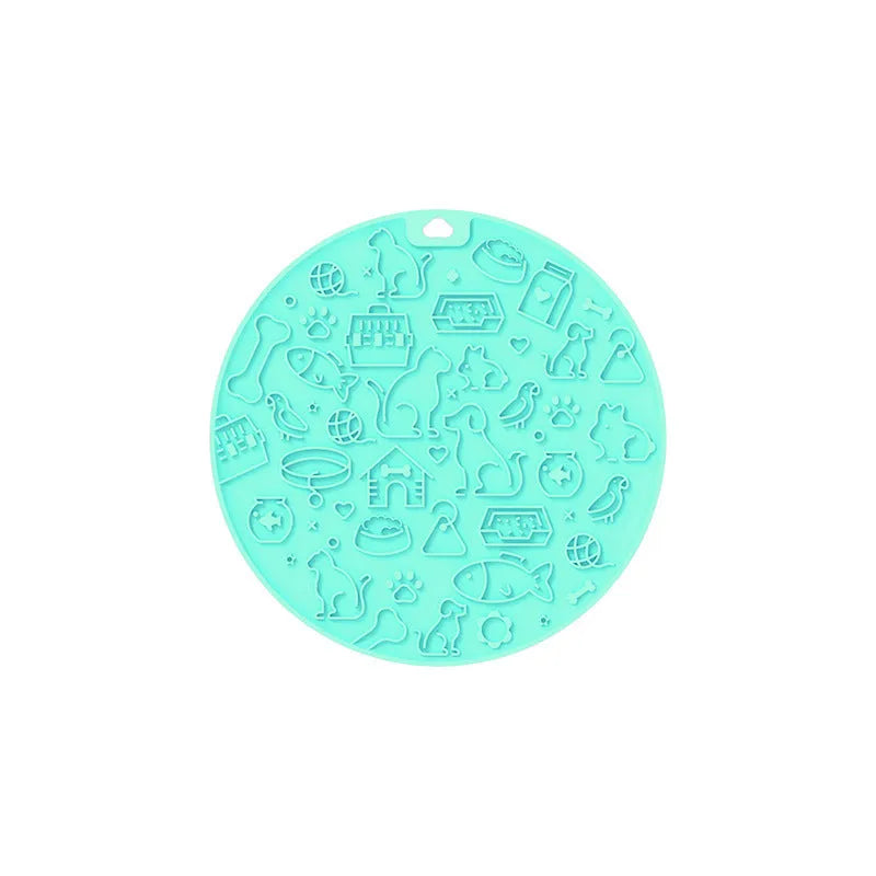Round silicone pet licking mat in blue colour with suction cup base on a tile floor.