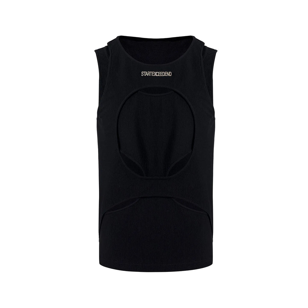 Man wearing a loose-fitting black sleeveless hollow thread waistcoat over a white t-shirt.