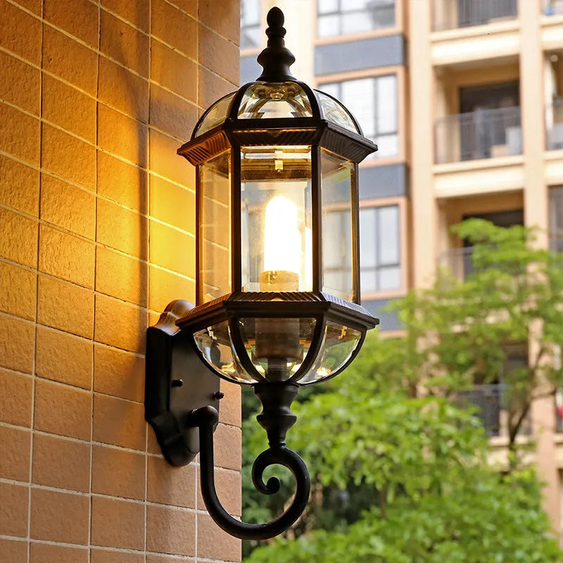 Gold aluminium outdoor wall lamp with three-layer design mounted on a brick wall.