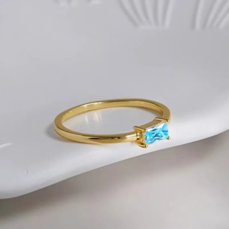 Sapphire blue zircon geometric bracelet ring for women on copper, showing oval and love shapes.