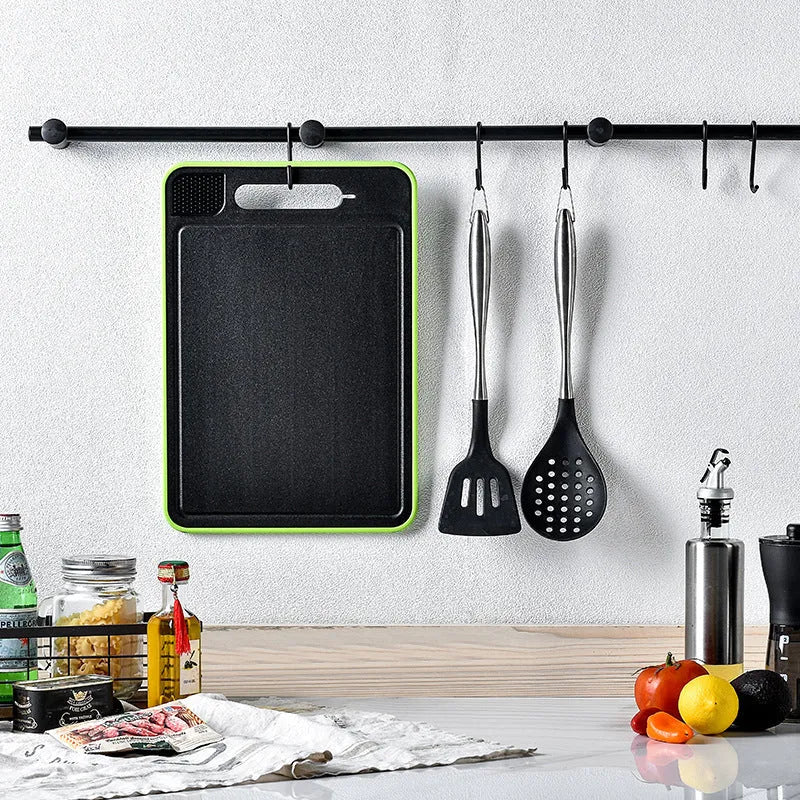 Grey square aluminium kitchen chopping board with double cutting sides, defrosting function and built-in knife sharpener