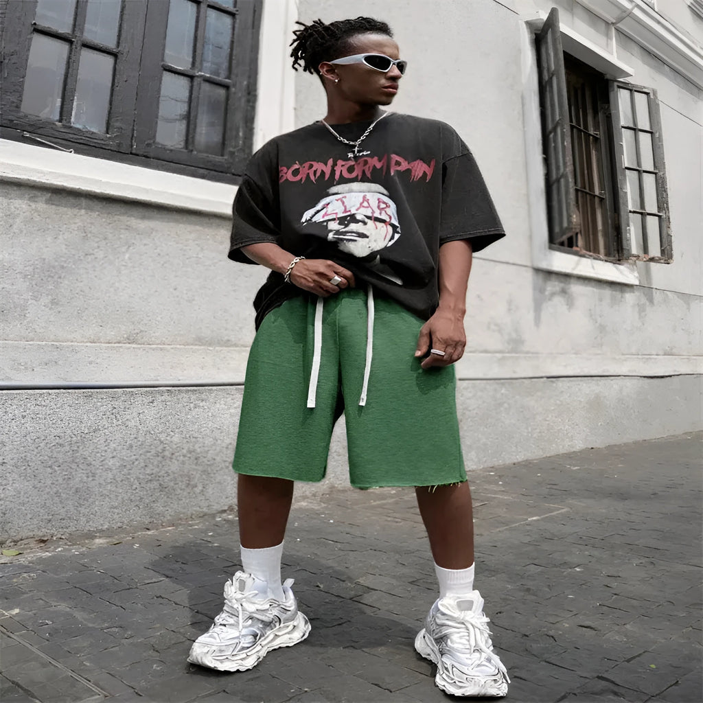 Men's straight-leg track trousers in black, shown in a casual streetwear style.