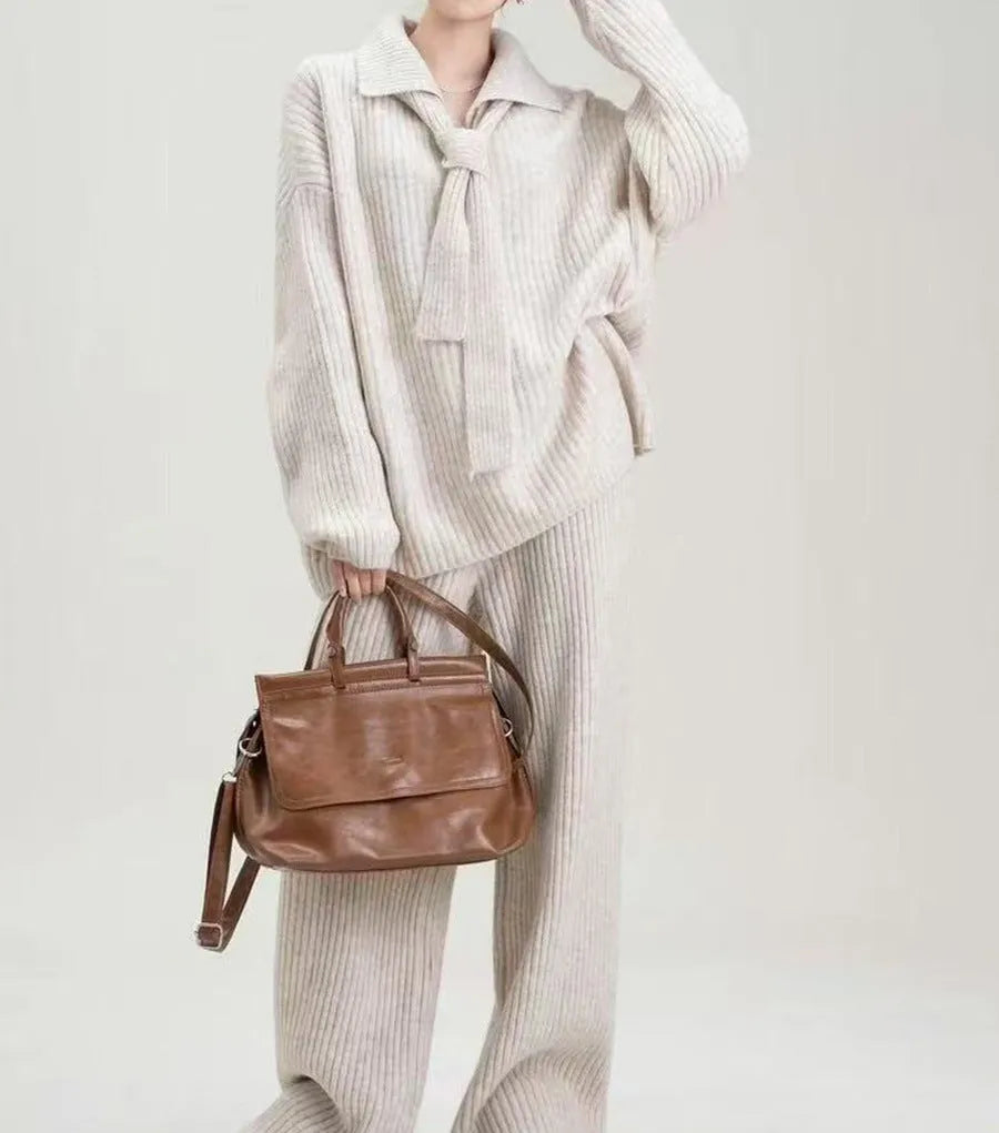 Women's beige knit two-piece set with long-sleeve top and trousers featuring collage stitch detail