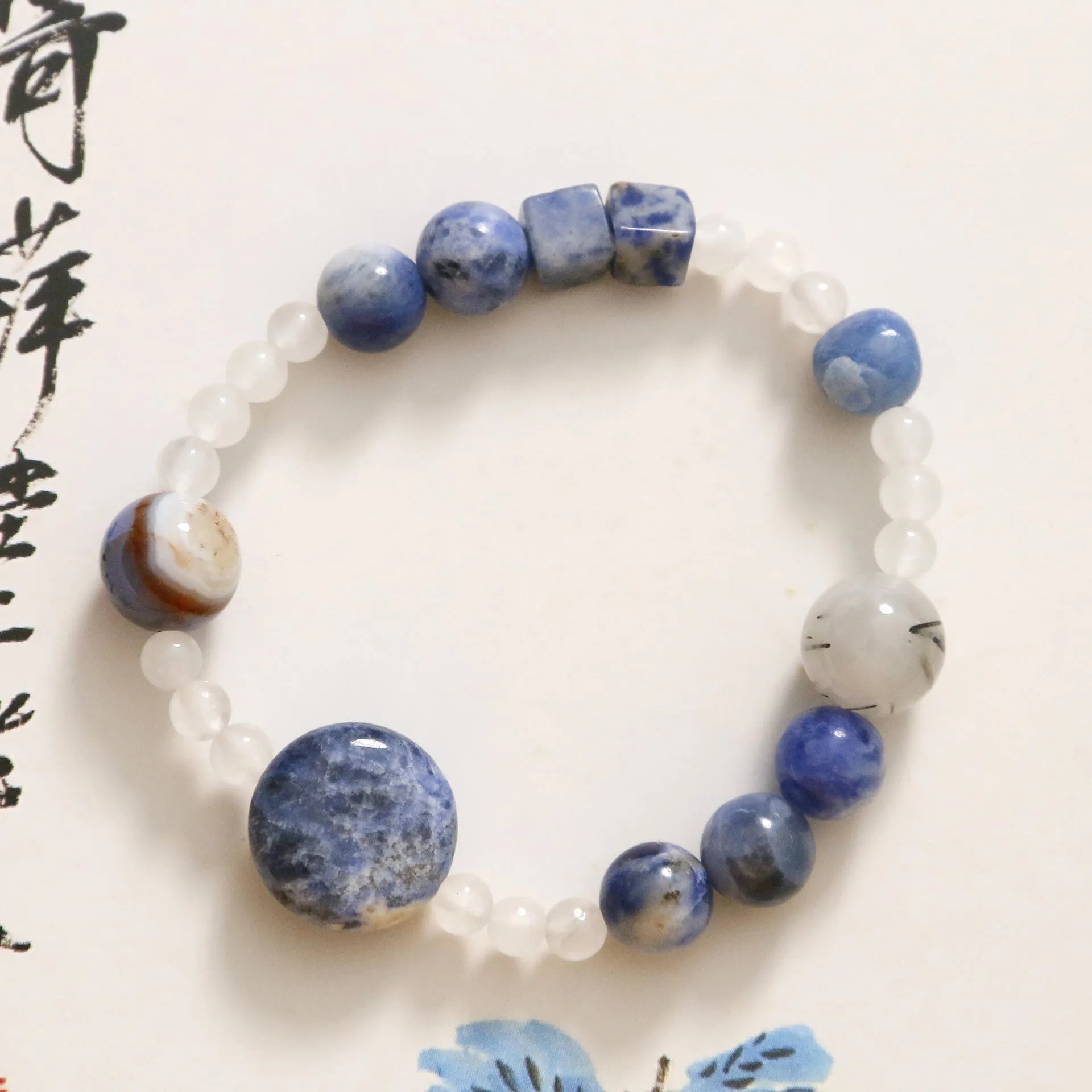Hand-woven natural blue point stone and black hair crystal agate bracelet with geometric design