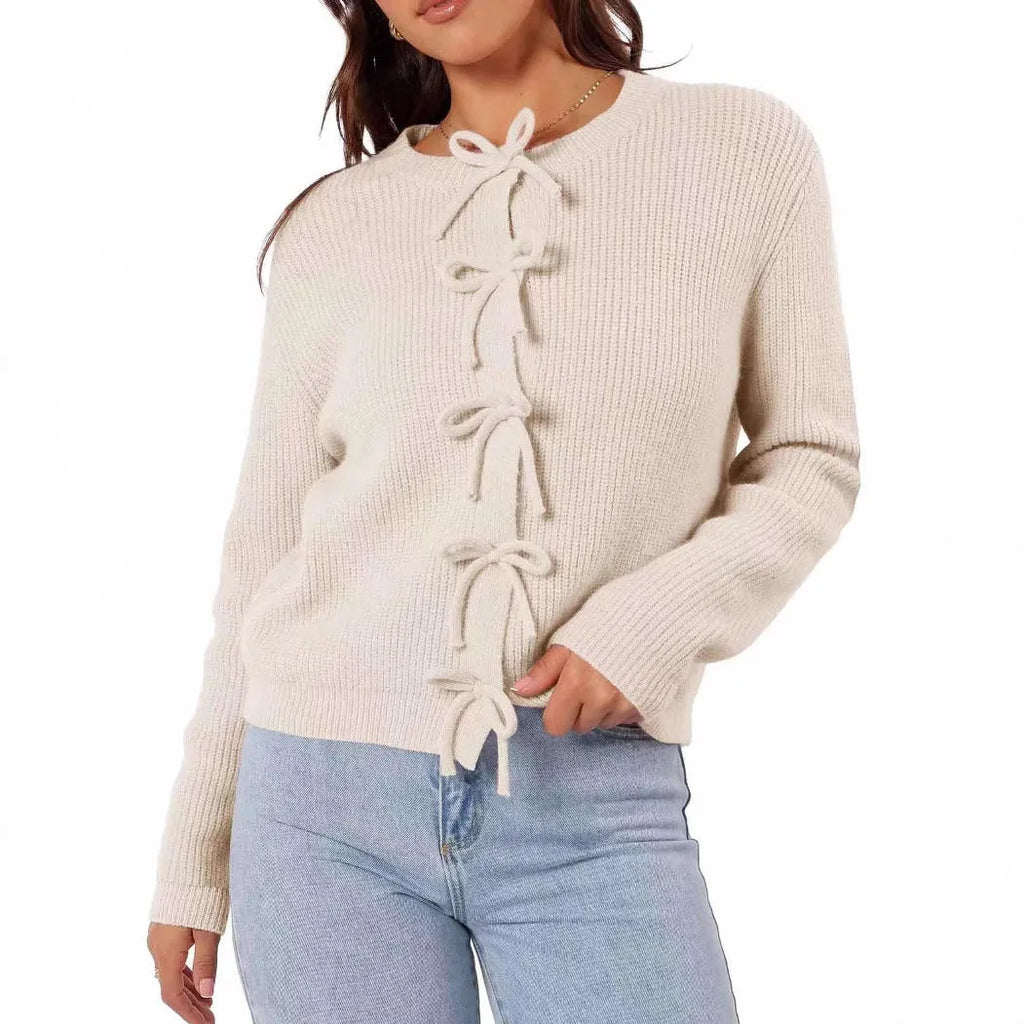 Women's long sleeve knitted cardigan with bow pattern in loose fit, available in multiple colours, shown on model