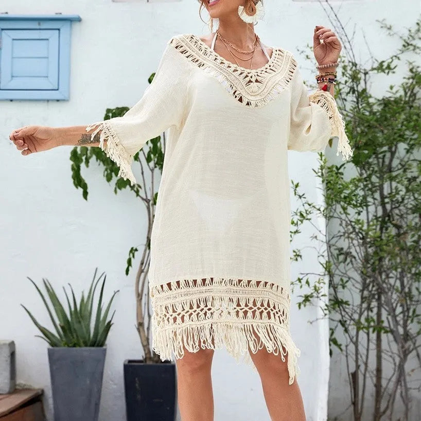 Apricot crocheted patchwork dress on a hanger showing regular sleeves and midi length.